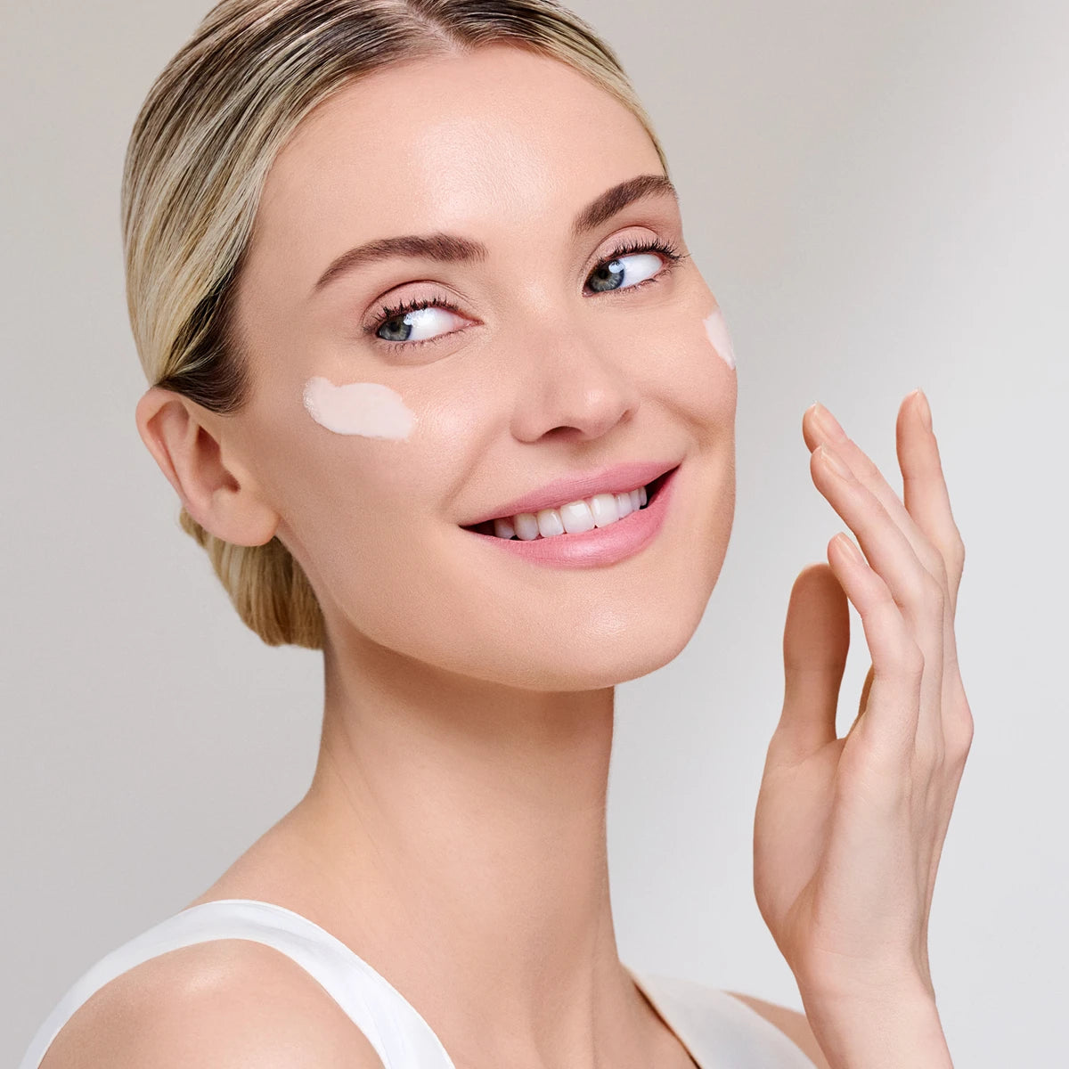 model applying Dr Ivy Skincare London Exosome Regenerative skincare products bio-hacking cream serum cleanser