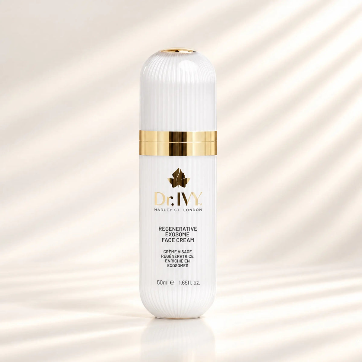 Dr Ivy Regenerative Exosome Face Cream 50ml in a white ribbed bottle with gold detailing against a warm ivory background.
