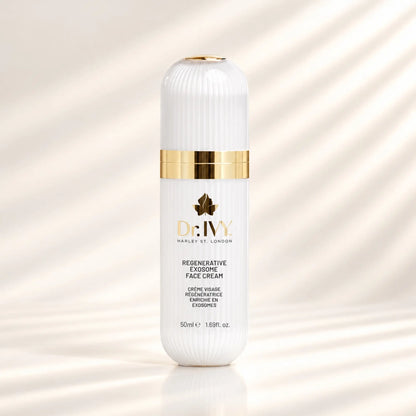 Dr Ivy Regenerative Exosome Face Cream 50ml in a white ribbed bottle with gold detailing against a warm ivory background.