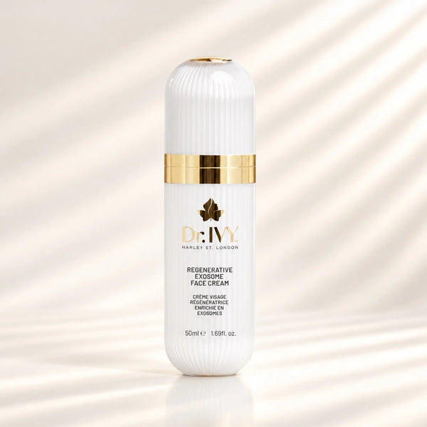 Dr Ivy Regenerative Exosome Face Cream 50ml in a white ribbed bottle with gold detailing against a warm ivory background.