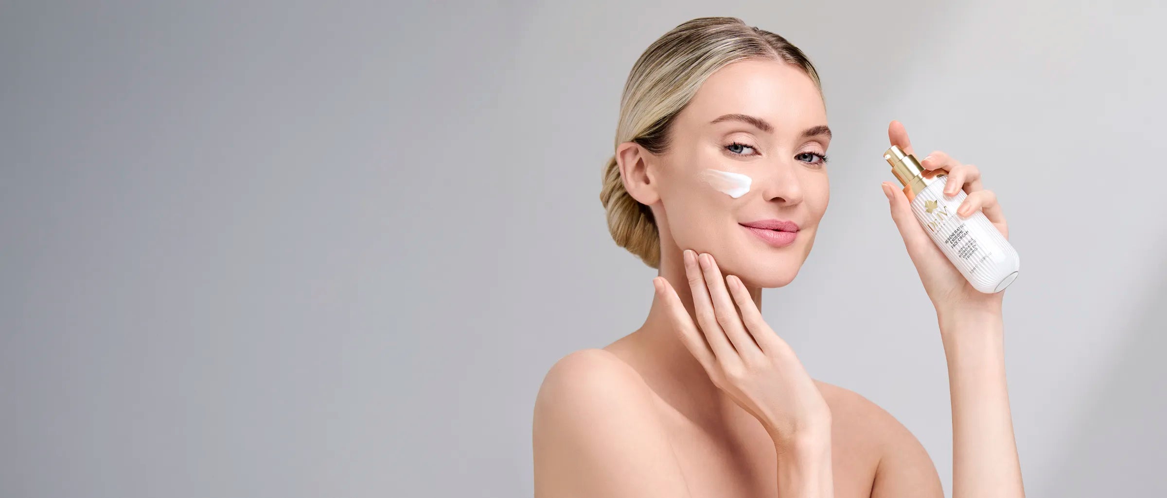 Model applying Dr Ivy Skincare London Exosome Regenerative skincare products bio-hacking cream serum cleanser