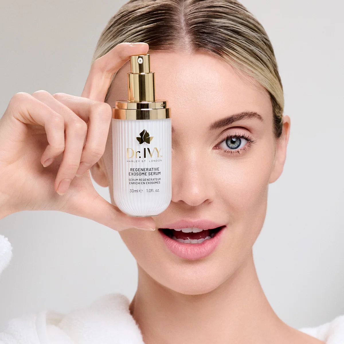 model holding a Dr Ivy Skincare London Exosome Regenerative skincare product bio-hacking serum